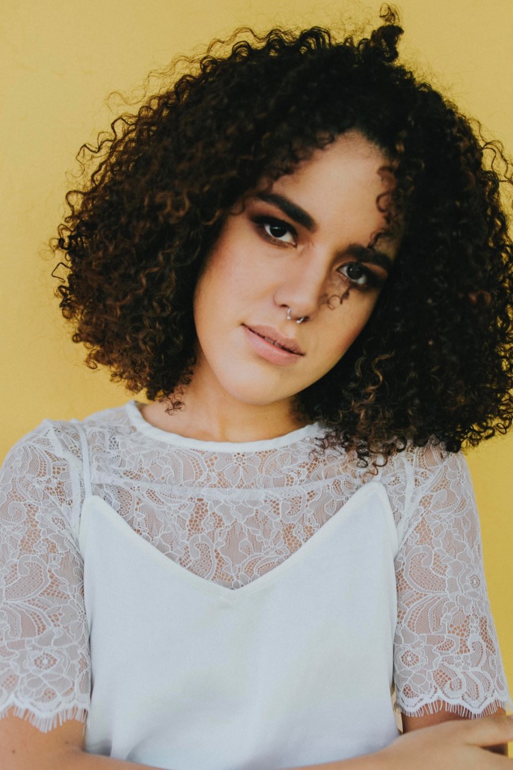Woman curly head tilt